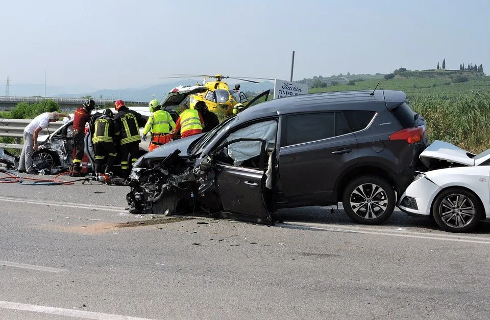 A wrecked SUV and sedan after a road accident
