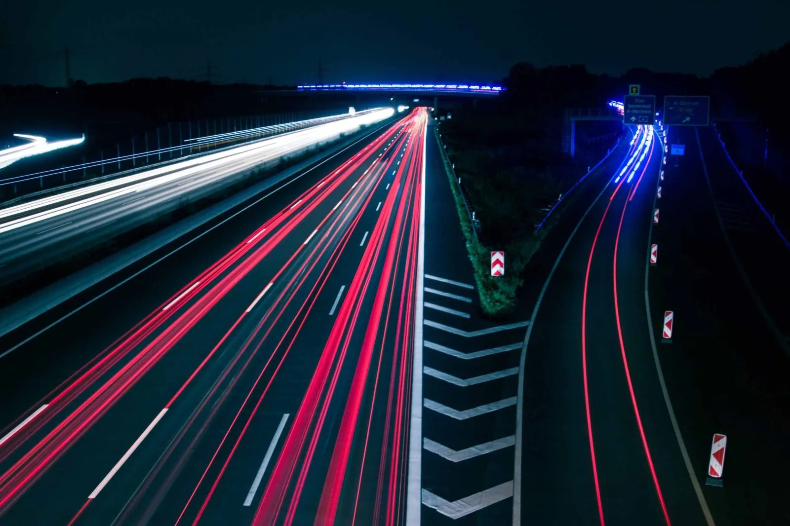 Light trails from traffic on a road at night